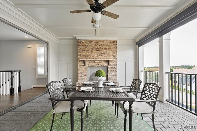 Balcony with a ceiling fan, a fireplace, and a patio | Image 31