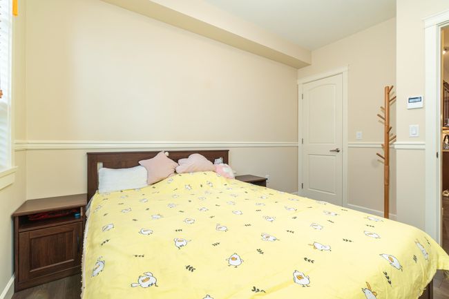 Bedroom with dark wood finished floors | Image 26