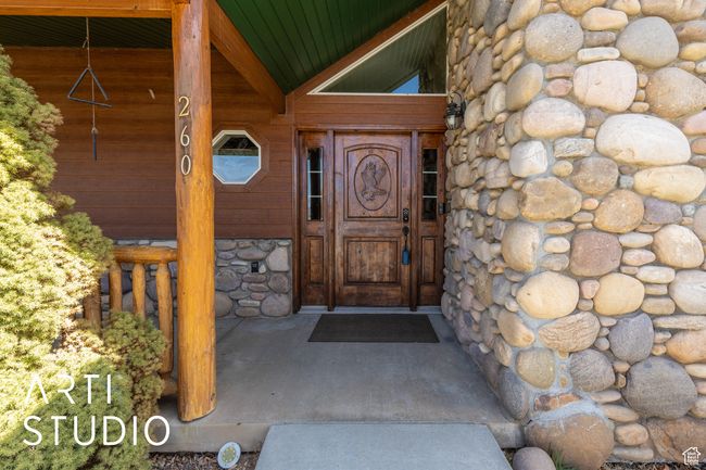 Entrance to property featuring stone siding | Image 14