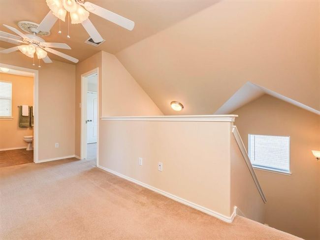 Carpeting runs up the stairway and into the bonus second floor living area and one of the bedrooms. | Image 16