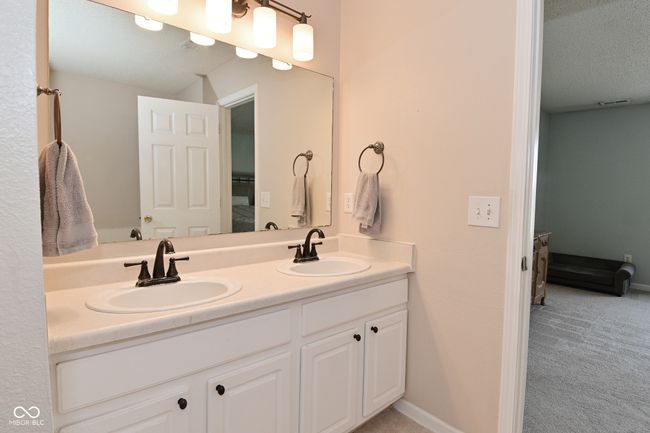bathroom featuring double vanity and baseboards | Image 45