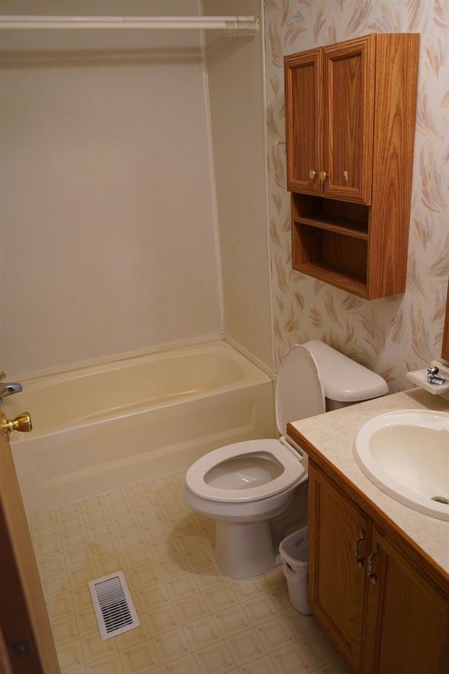 Full bathroom featuring wallpapered walls, vanity, and bathing tub / shower combination | Image 17