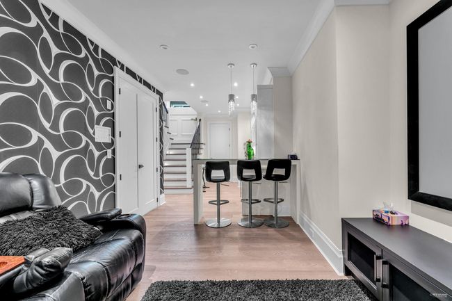 Living area with stairway, wood finished floors, baseboards, ornamental molding, and recessed lighting | Image 20