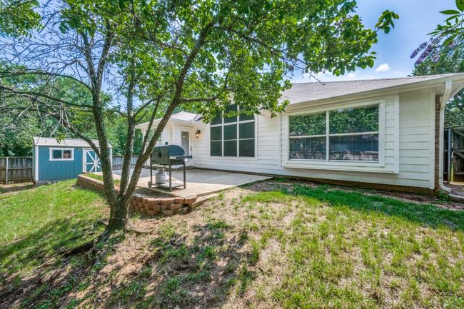 Rear view of property featuring a patio and a storage unit | Image 17