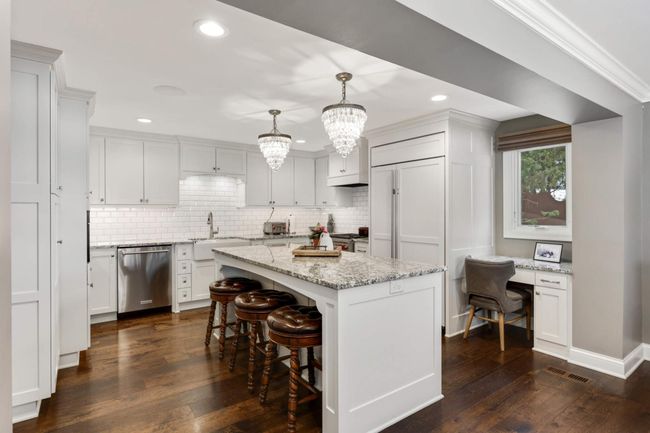 Kitchen has center island, tons of storage and desk nook too | Image 16
