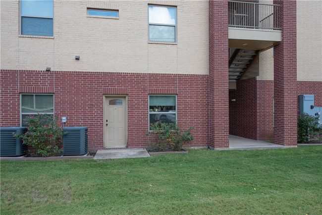 Rear view of property with brick siding, a yard, and cooling unit | Image 18