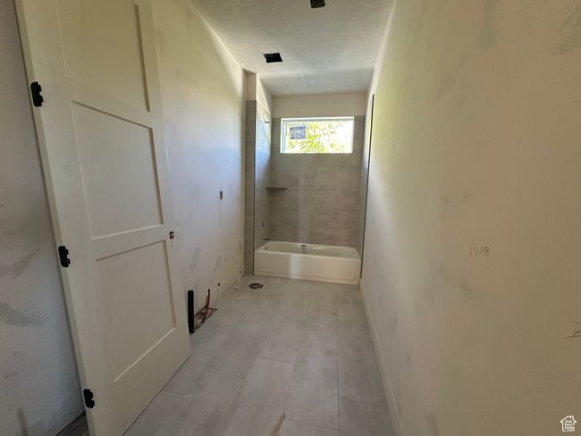 Full bathroom with baseboards and bathing tub / shower combination | Image 14