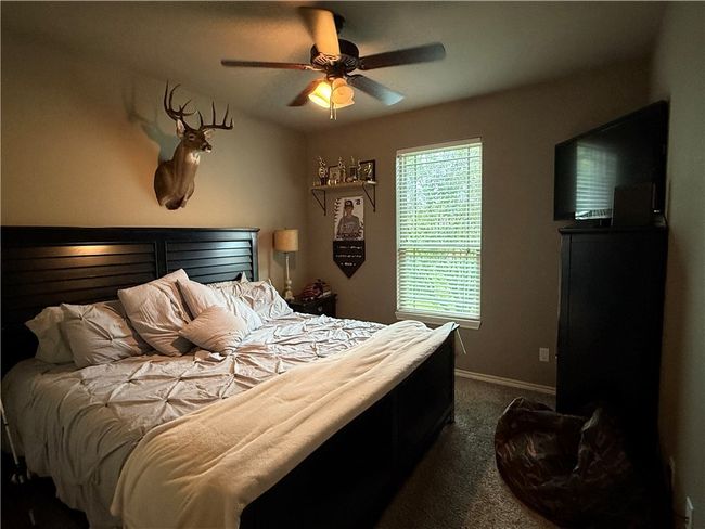 Carpeted bedroom featuring baseboards and a ceiling fan | Image 17