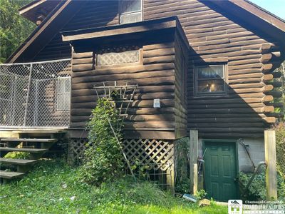 Side of house showing outside entrance to basement | Image 3