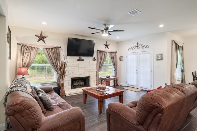 Upgraded ceiling fan, a lot of natural light fills the room, a great size to host parties. | Image 7