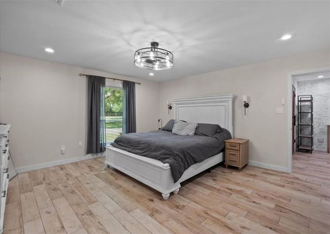Serene and spacious primary suite with a beautiful front yard view and private ensuite. | Image 26