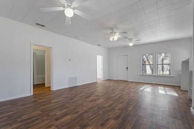 Unfurnished living room with ornamental molding, dark hardwood / wood-style floors, and ceiling fan | Image 11