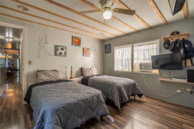 Bedroom with wood finished floors and cooling unit | Image 14