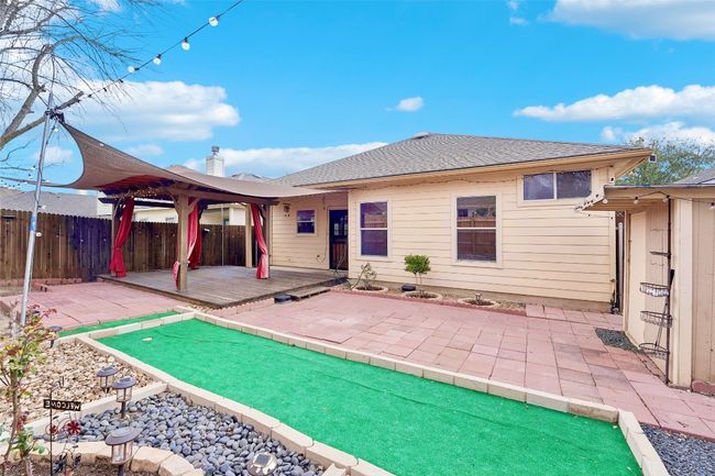 Rear view of house with a patio, fence, roof with shingles, and a gazebo | Image 21