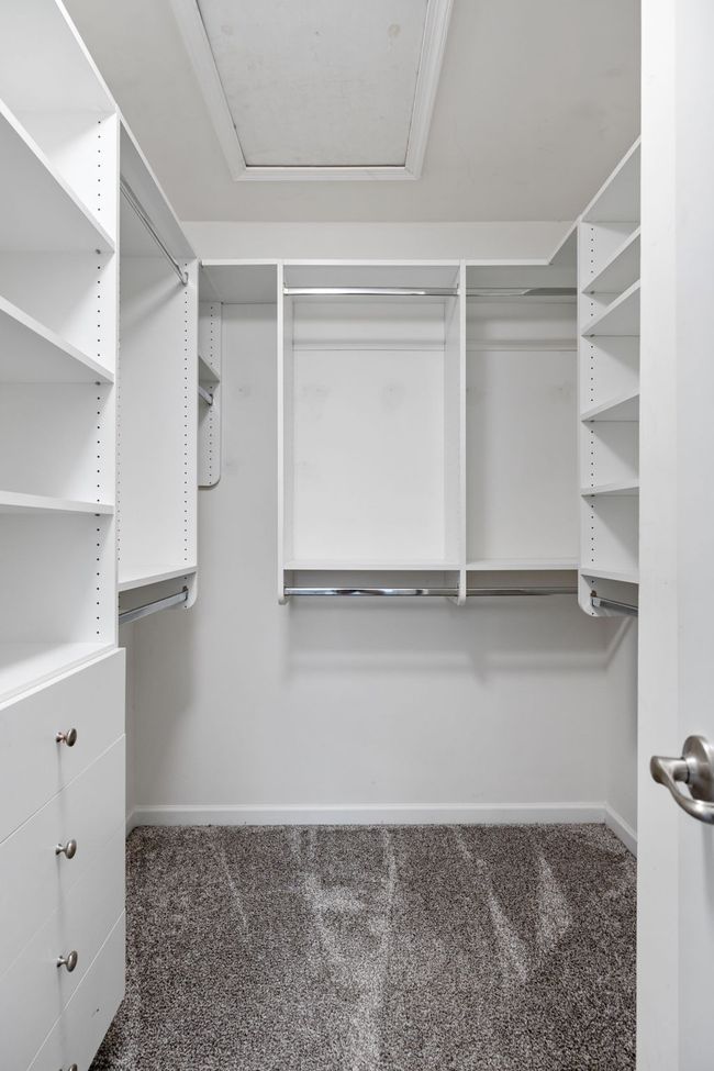 The walk in closet is not fully captured here. The custom organizer maximizes the space including hanging, open shelving as well as pull out drawers | Image 21