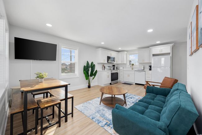 Living area with light wood-type flooring, recessed lighting, and baseboards | Image 35