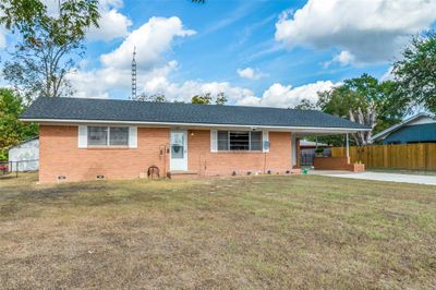 Single story home featuring a front yard and a carport | Image 2