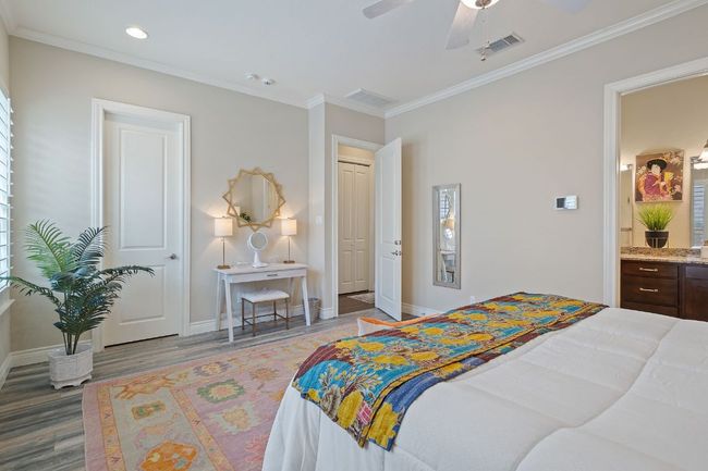 2nd Floor Primary Bedroom featuring baseboards, wood finished floors, visible vents, and crown molding | Image 21