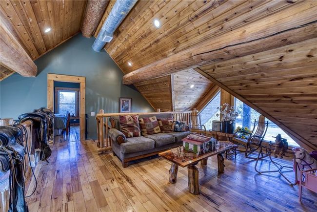 Living area with beam ceiling, wooden ceiling, high vaulted ceiling, and wood-type flooring | Image 12