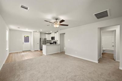 Carpeted living room flows directly to your chef-ready kitchen. | Image 2