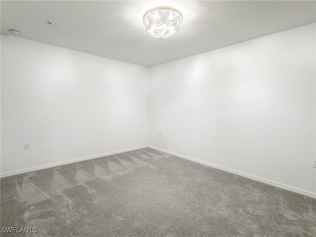 Spare room featuring carpet floors, baseboards, and a smoke detector | Image 22
