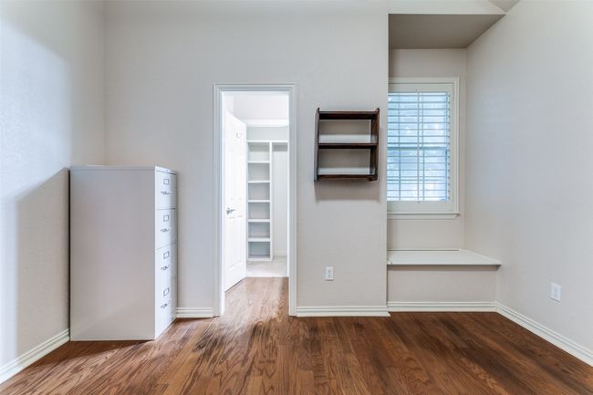 Bedroom with built in seat/storage area walk in closet and jack-and-Jill bathroomcloset, wood finished floors, baseboards, and a closet | Image 21