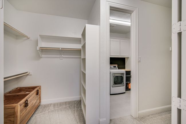 Walk in closet with washer / dryer and light colored carpet | Image 21