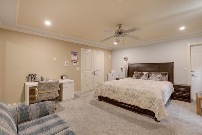 Bedroom featuring ornamental molding, ceiling fan, light carpet, and baseboards | Image 19