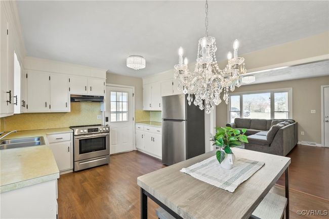 Kitchen featuring light countertops, a sink, stainless steel appliances, and dark wood-style floors | Image 9