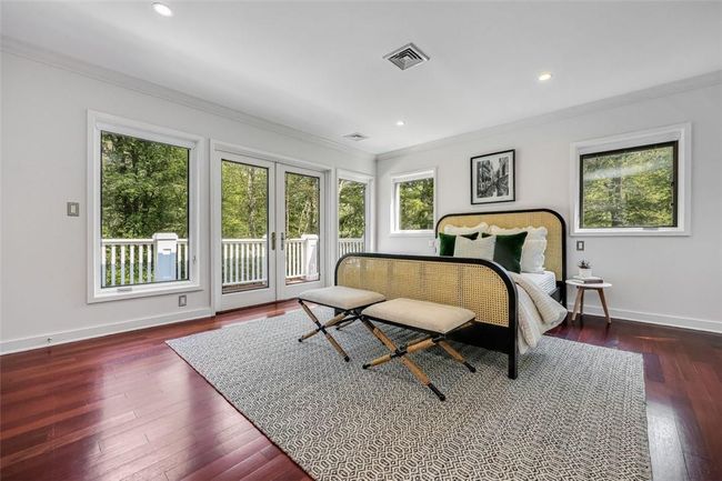 Bedroom with dark hardwood / wood-style floors, access to outside, crown molding, and french doors | Image 16