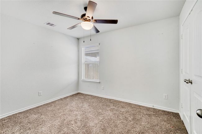 Carpeted empty room featuring ceiling fan | Image 28