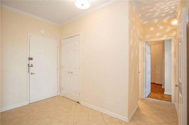 From the tiled Entry Foyer with coat closet you can turn to the left to find the Bedroom wing. | Image 16