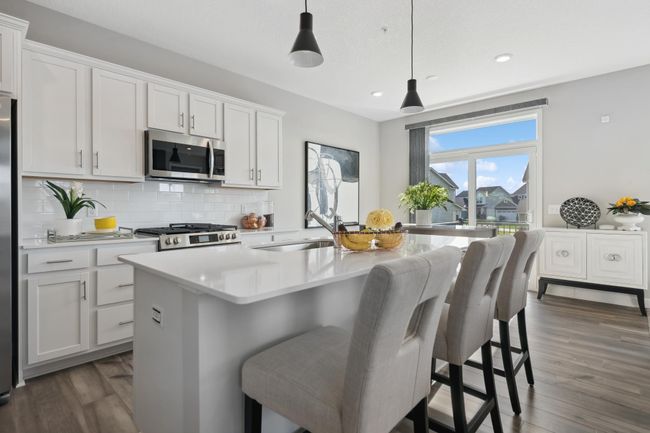 (Photo of decorated model, actual home's finishes will vary) Enjoy meals of any kind in the comfortable dining room, located among the open floorplan for ease of use. | Image 6