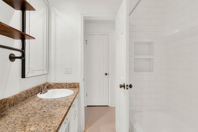 Bathroom featuring vanity, tile patterned floors, and bathing tub / shower combination | Image 14