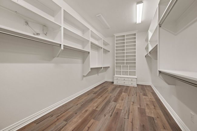 Spacious closet with wood finished floors, lots of built-ins | Image 29
