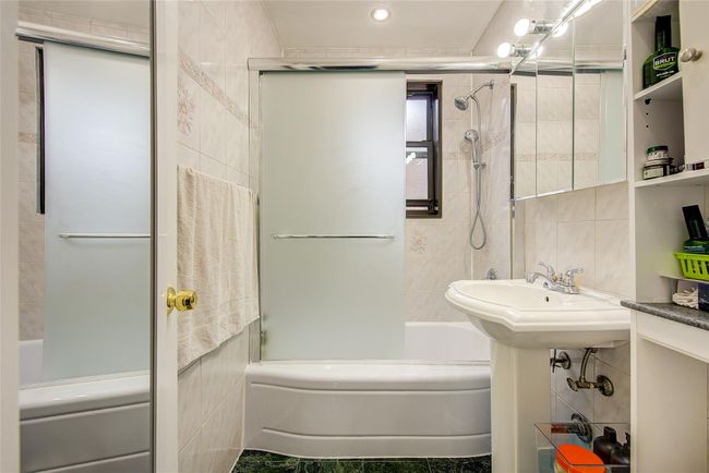 Bathroom featuring tile walls, shower / washtub combination, and recessed lighting | Image 19