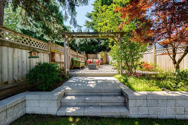 Fenced backyard with a patio and outdoor lounge area | Image 36