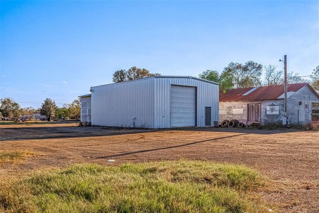The 35x45 shop features concrete floors, electricity, an insulated metal roof, and two 14-foot bay doors. | Image 5