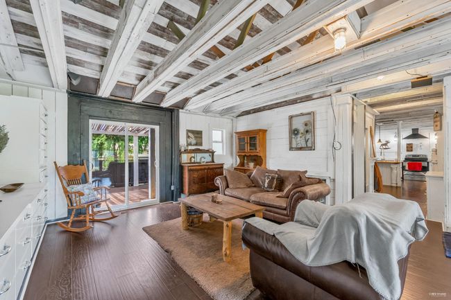Living room with wood walls and hardwood / wood-style floors | Image 21