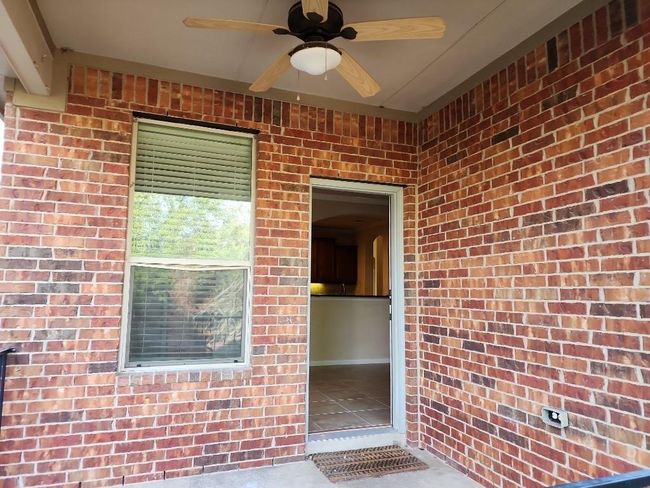 View of exterior entry featuring brick siding and ceiling fan | Image 29