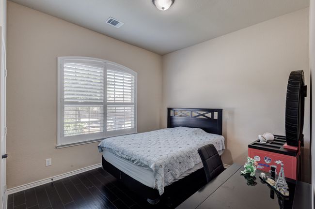 Bedroom featuring multiple windows, baseboards, and dark wood finished floors | Image 19