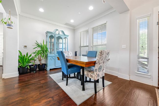 Dining room with plenty of natural light, crown molding, dark wood-type flooring, and recessed lighting | Image 4