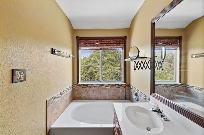 Full bath with vanity, a garden tub, and a textured wall | Image 29