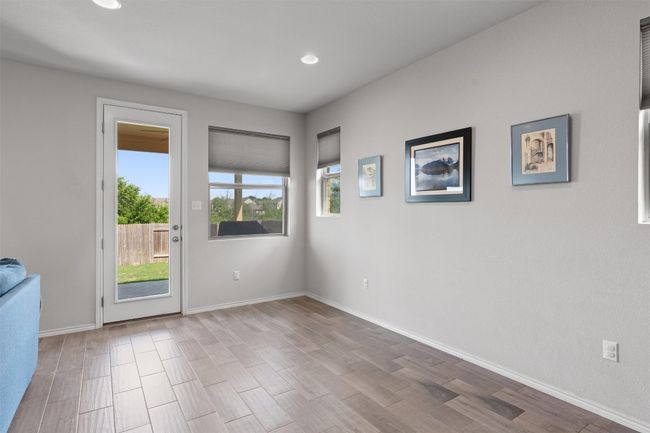 A sun-filled dining area with direct access to the backyard. | Image 11