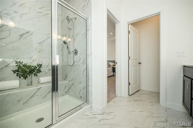 Full bathroom featuring marble finish flooring, a marble finish shower, and vanity | Image 25