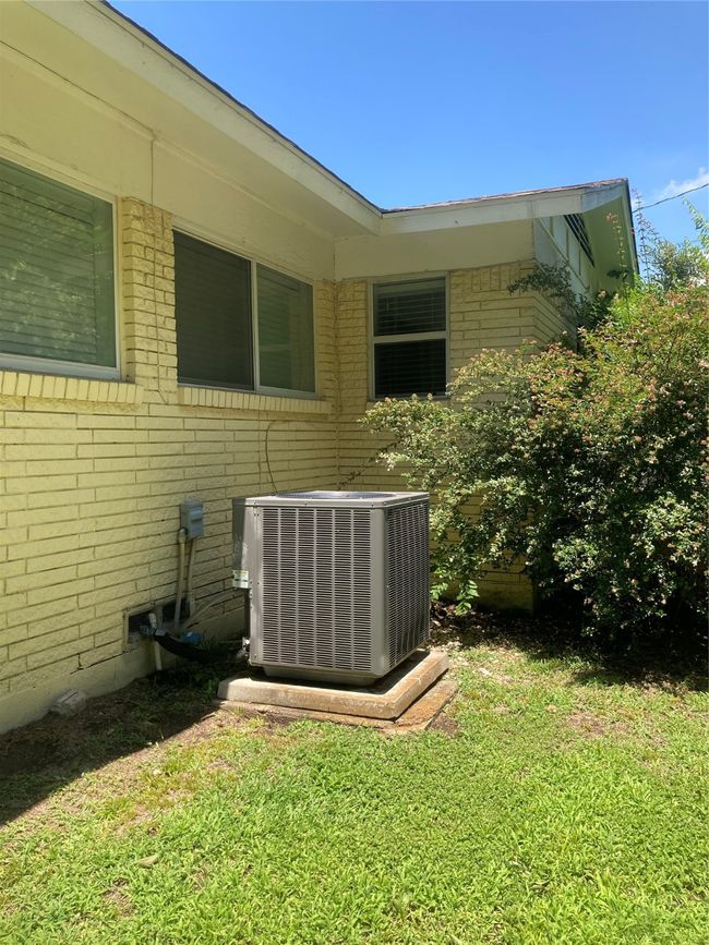 View of green lawn featuring central AC unit | Image 11