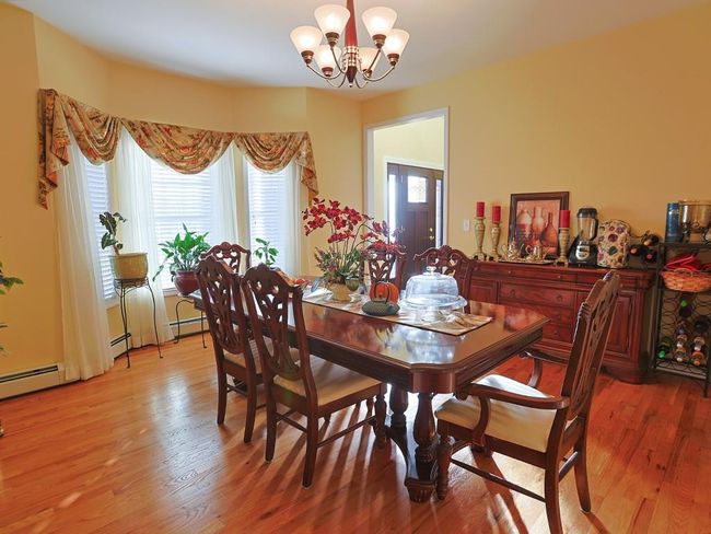 Dining area with an inviting chandelier and light wood-type flooring | Image 5