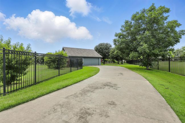 Surrounding community with concrete driveway and a garage | Image 7