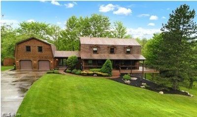 View of front of house with a garage and a front yard | Image 1