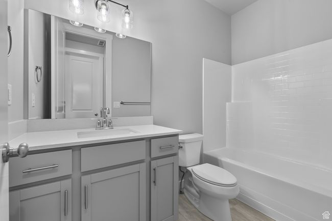 Bathroom featuring vanity, wood finished floors, and bathtub / shower combination | Image 5